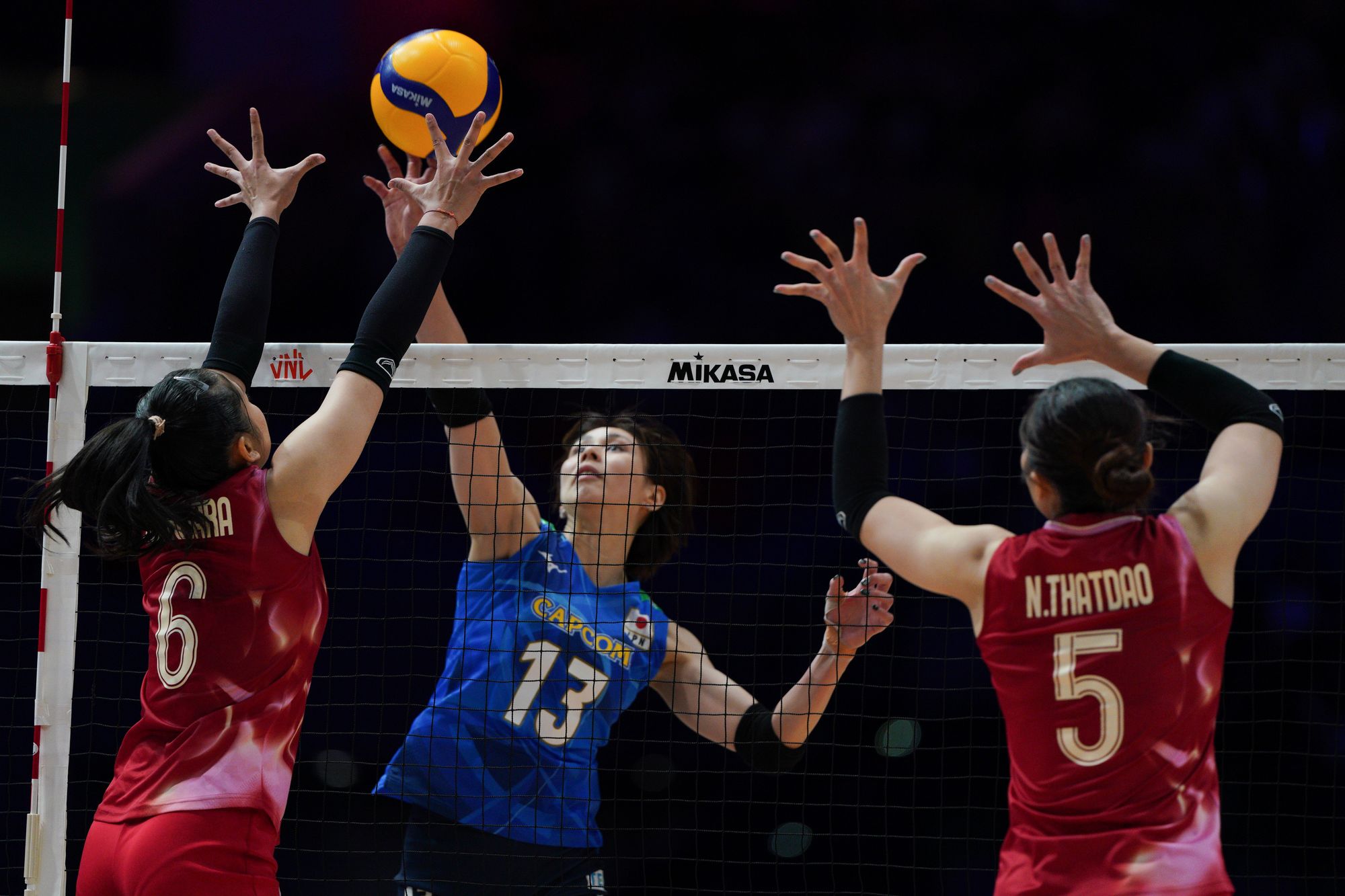 Japan player Yukiko Wada (number 13) play the ball against Thailand.