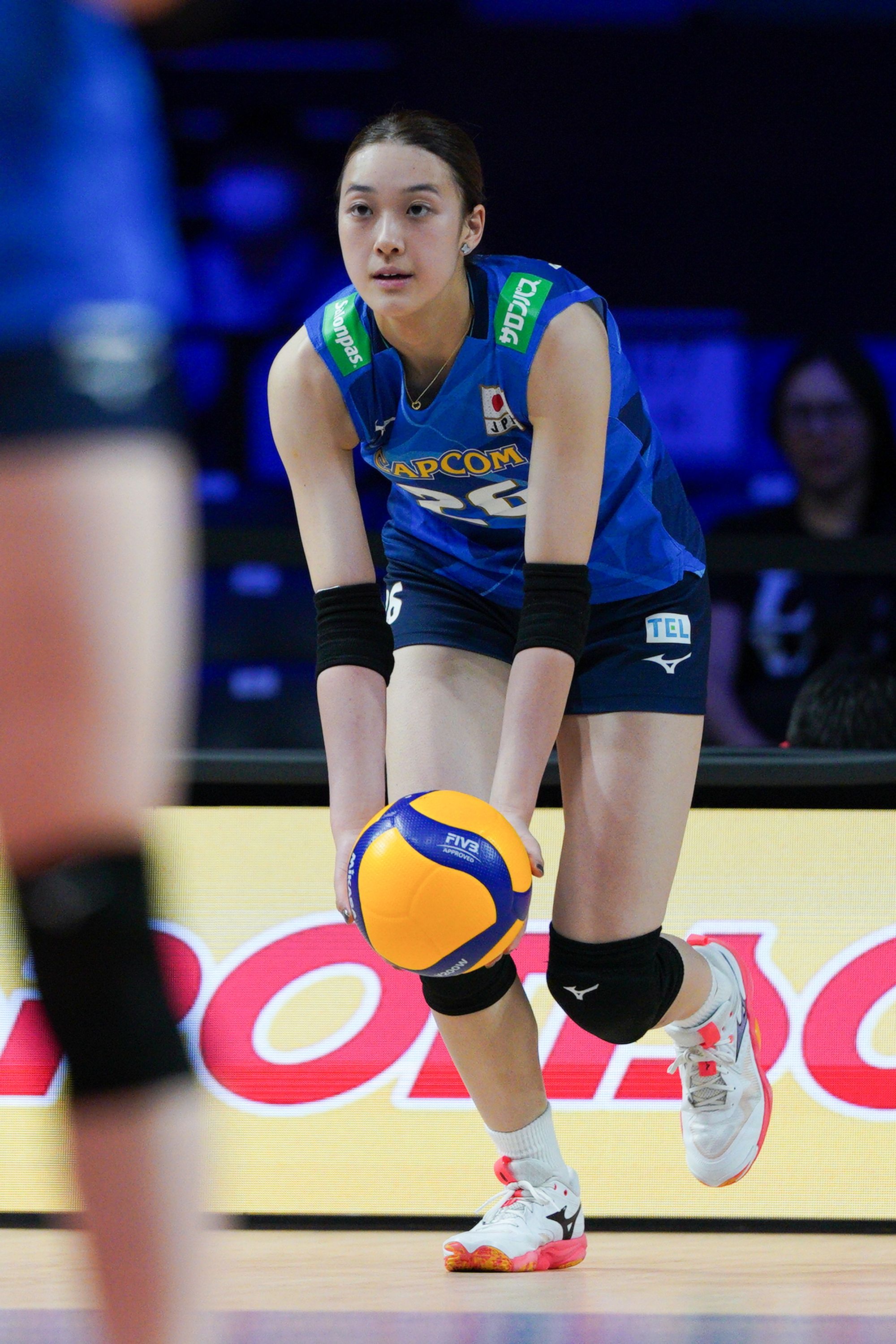 Japan player Yoshino Sato (number 26) jump service in the game.
