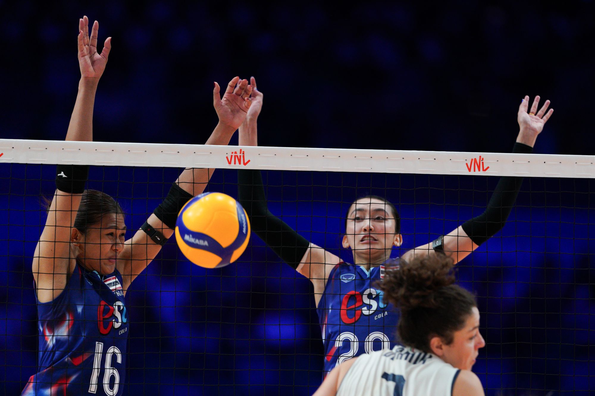Team Thailand player Kokram Pimpichaya (number 16), Thanapan Wimonrat (number 29) block the ball.