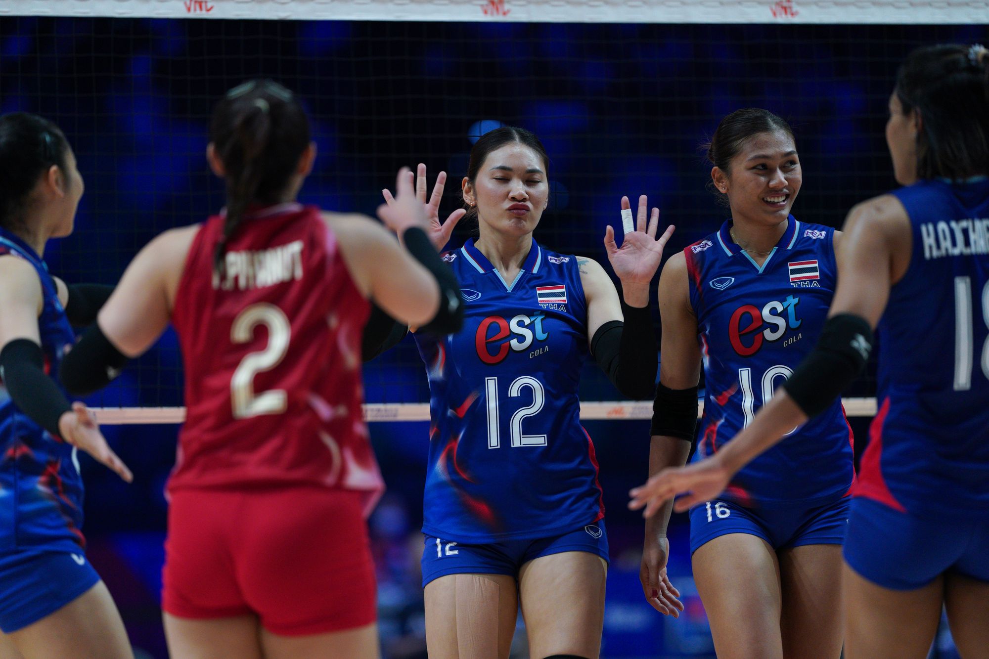 Team Thailand player Bamrungsuk Hattaya (number 12), Kokram Pimpichaya (number 16) and teammates in the game.