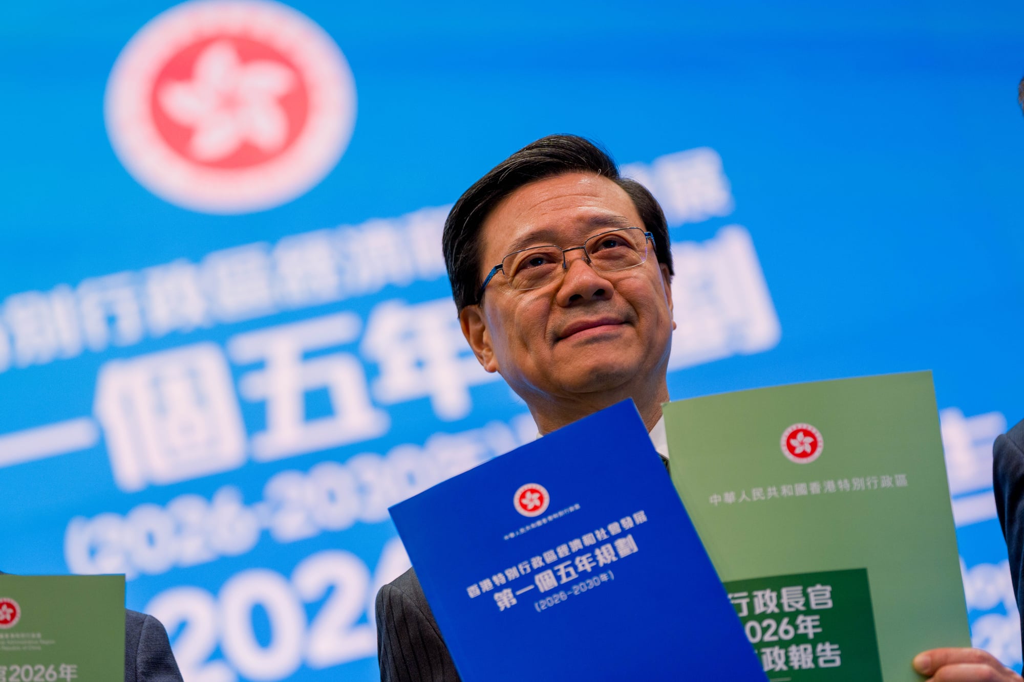 Hong Kong Chief Executive John Lee holding on Five Year Plan and Policy Address.