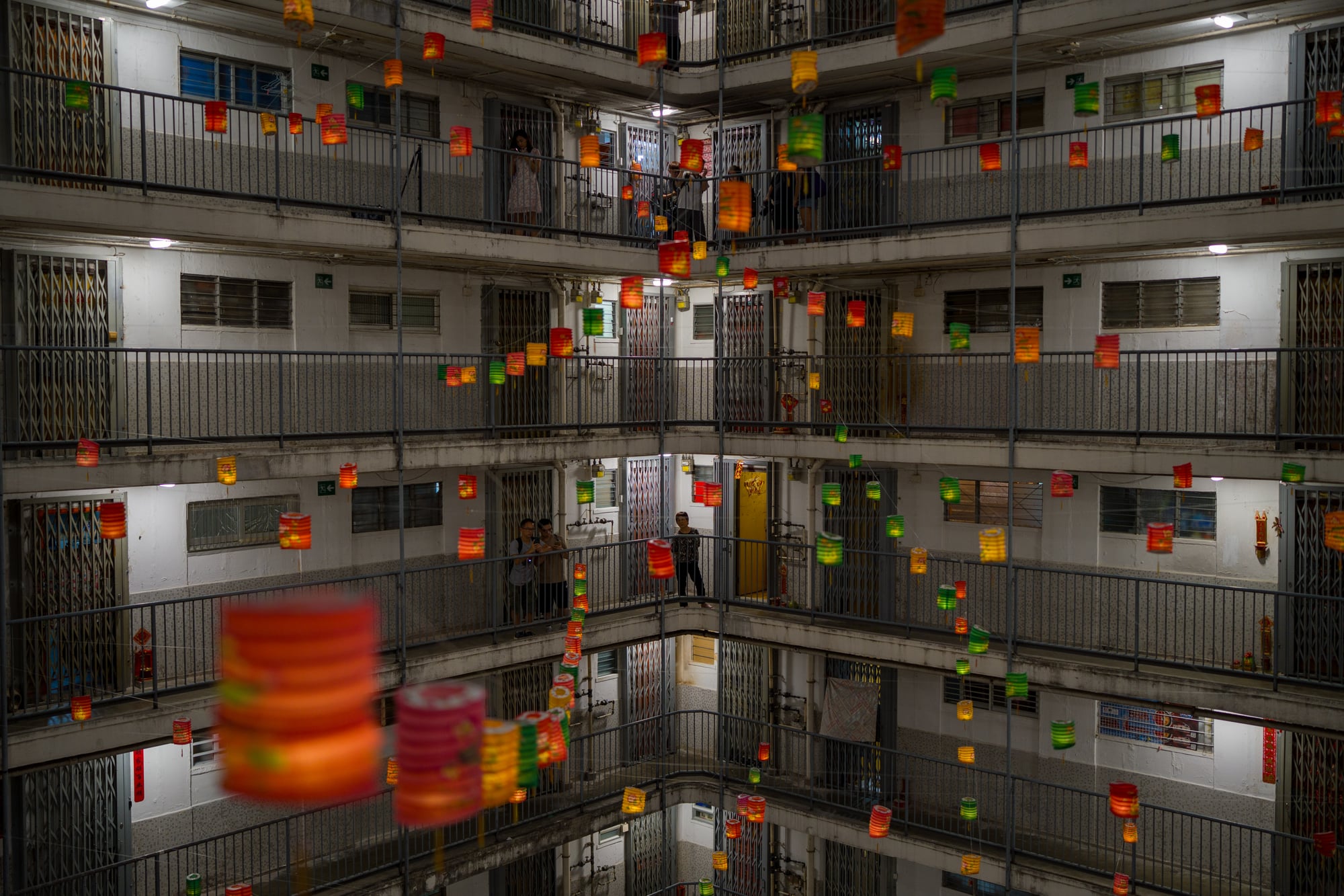 Lanterns hanging from a balcony at a housing estate
