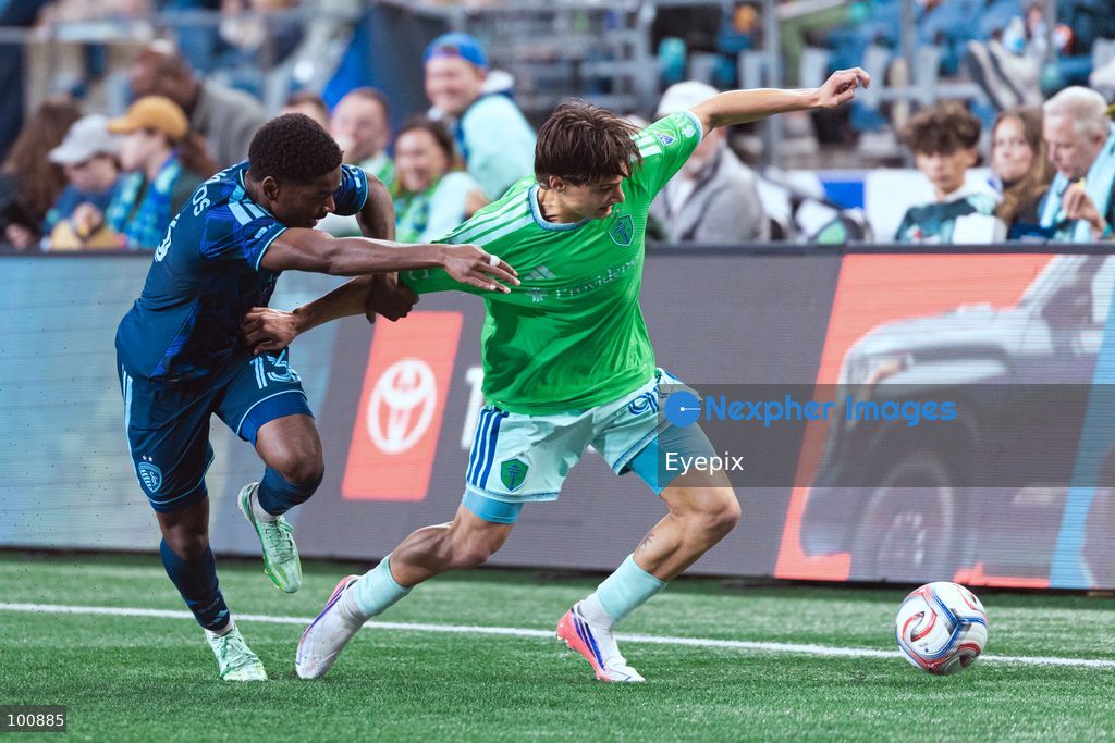 Justin Reynolds #13 of Sporting Kansas City and Sebastian Gomez #90 of Seattle Sounders FC battle for the ball during the MLS match between Sounders FC and Sporting Kansas City at Lumen Field. on October 1, 2026 in Seattle, Washington. (Photo by Jules Doyle/ Eyepix Group) (Photo by Jules Doyle/ Eyepix Group/Eyepix via Nexpher Images)