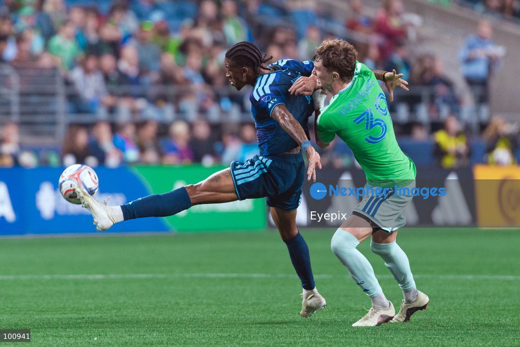 André Luiz #11 of Sporting Kansas City is pressured by Stuart Hawkins #39 of Seattle Sounders FC during the MLS match between Sounders FC and Sporting Kansas City at Lumen Field. on October 1, 2026 in Seattle, Washington. (Photo by Jules Doyle/ Eyepix Group) (Photo by Jules Doyle/ Eyepix Group/Eyepix via Nexpher Images)