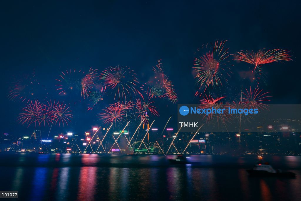 A general view captured from the viewing deck outside the Hong Kong Cultural Centre in Tsim Sha Tsui shows fireworks exploding in vibrant colours above Victoria Harbour against the backdrop of illuminated skyscrapers along the Hong Kong Island skyline during the 77th National Day celebrations on October 1, 2026 in Hong Kong. (Photo by Gordon Choi/TMHK via Nexpher Images)