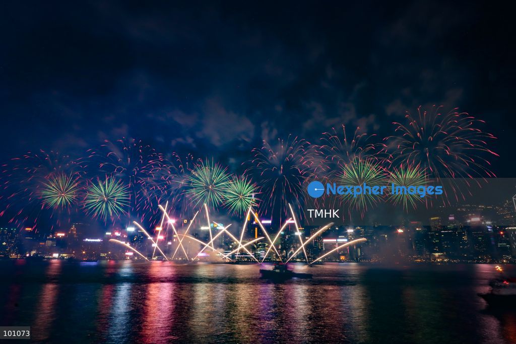A general view captured from the viewing deck outside the Hong Kong Cultural Centre in Tsim Sha Tsui shows fireworks exploding in vibrant colours above Victoria Harbour against the backdrop of illuminated skyscrapers along the Hong Kong Island skyline during the 77th National Day celebrations on October 1, 2026 in Hong Kong. (Photo by Gordon Choi/TMHK via Nexpher Images)