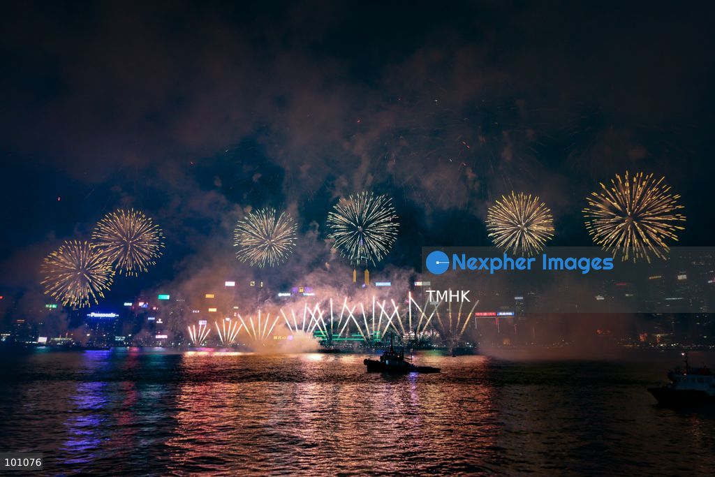 A general view captured from the viewing deck outside the Hong Kong Cultural Centre in Tsim Sha Tsui shows fireworks exploding in vibrant colours above Victoria Harbour against the backdrop of illuminated skyscrapers along the Hong Kong Island skyline during the 77th National Day celebrations on October 1, 2026 in Hong Kong. (Photo by Gordon Choi/TMHK via Nexpher Images)