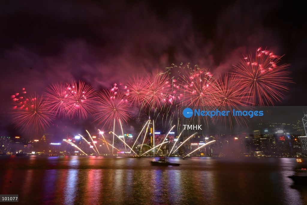 A general view captured from the viewing deck outside the Hong Kong Cultural Centre in Tsim Sha Tsui shows fireworks exploding in vibrant colours above Victoria Harbour against the backdrop of illuminated skyscrapers along the Hong Kong Island skyline during the 77th National Day celebrations on October 1, 2026 in Hong Kong. (Photo by Gordon Choi/TMHK via Nexpher Images)