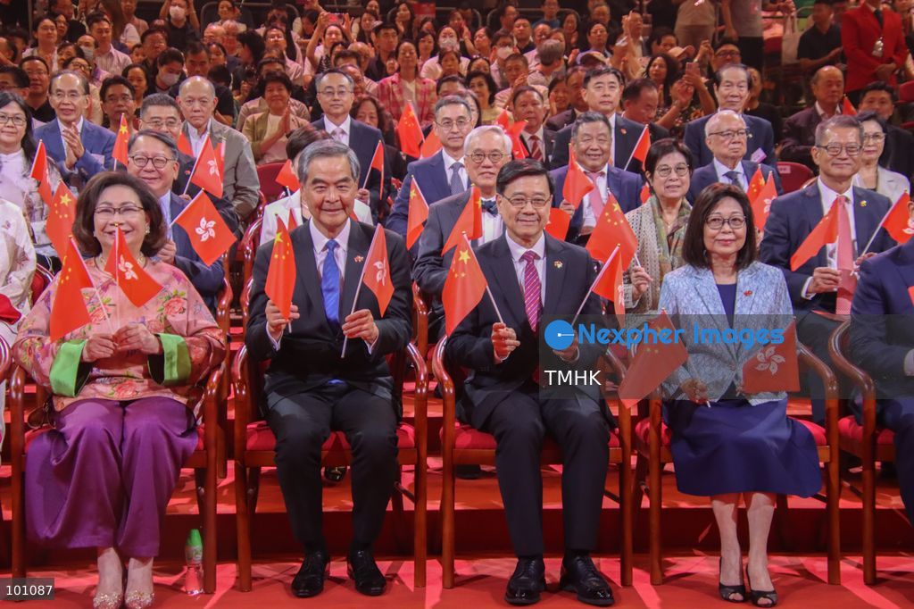 Hong Kong Chief Executive John Lee Ka-chiu and his wife, Janet Lam Lai-sim, along with Vice Chairman of the National Committee of the CPPCC Leung Chun-ying and his wife, Regina Higgins Leung (front row), join Financial Secretary Paul Chan Mo-po, Chief Secretary for Administration Eric Chan Kwok-ki, former Chief Executive Carrie Lam Cheng Yuet-ngor, and former Chief Executive Donald Tsang Yam-kuen with his wife, Selina Pow Tsang (second row), for a group photo ahead of the performance at the variety show celebrating the 77th anniversary of the founding of the People's Republic of China at the Hong Kong Coliseum in Hung Hom on October 2, 2026 in Hong Kong. (Photo by Gordon Choi/TMHK via Nexpher Images)