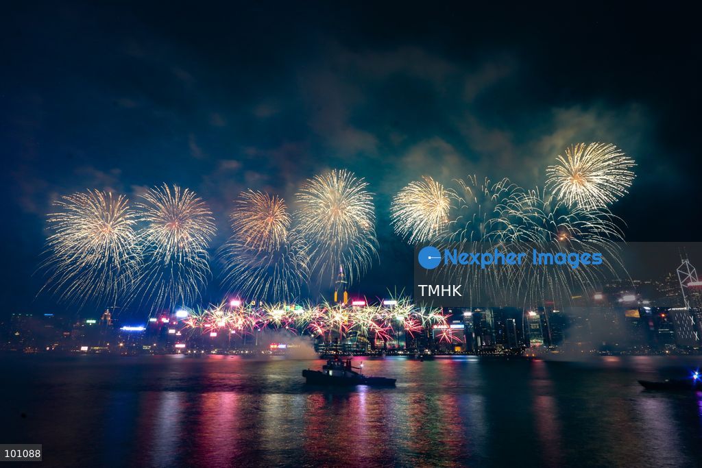 A general view captured from the viewing deck outside the Hong Kong Cultural Centre in Tsim Sha Tsui shows fireworks exploding in vibrant colours above Victoria Harbour against the backdrop of illuminated skyscrapers along the Hong Kong Island skyline during the 77th National Day celebrations on October 1, 2026 in Hong Kong. (Photo by Gordon Choi/TMHK via Nexpher Images)