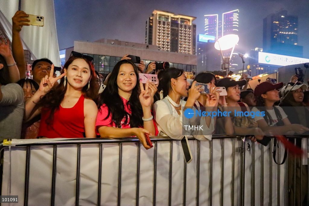 Crowds of citizens and tourists pack the waterfront promenade outside the Hong Kong Cultural Centre in Tsim Sha Tsui, holding up their smartphones to film and photograph the fireworks display illuminating Victoria Harbour during the 77th National Day celebrations on October 1, 2026 in Hong Kong. (Photo by Gordon Choi/TMHK via Nexpher Images)