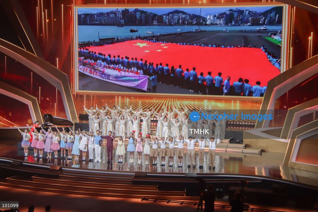 A general view shows artistes performing on stage under dramatic illumination during the variety show celebrating the 77th anniversary of the founding of the People's Republic of China before more than 5,000 spectators at the Hong Kong Coliseum in Hung Hom on October 2, 2026 in Hong Kong. (Photo by Gordon Choi/TMHK via Nexpher Images)