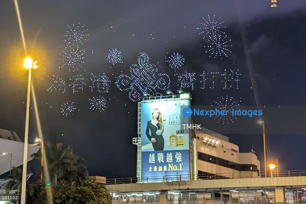 A close-up view captured from the Cross-Harbour Tunnel Bus-Bus Interchange shows hundreds of illuminated drones forming the Chinese characters for "Striving Together for Hong Kong" in the night sky above the Hung Hom waterfront during the 77th National Day drone light show on October 2, 2026 in Hong Kong, rallying community spirit and unity during the celebratory weekend. (Photo by Judy Cheung/TMHK via Nexpher Images)