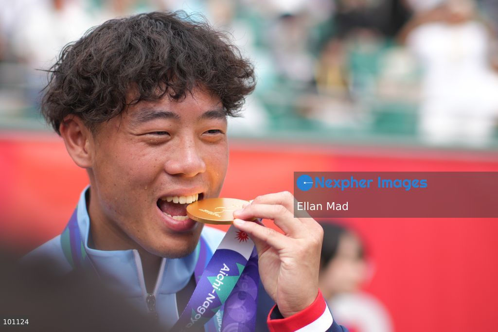 Hong Kong Tennis player, Coleman Wong Chak-lam bite the gold medal and posing photo, he wins the Men's Final at the 2026 Asian games on October 3, 2026 in Nagoya, Japan. (Photo by Ellan Mad/Nexpher Images)