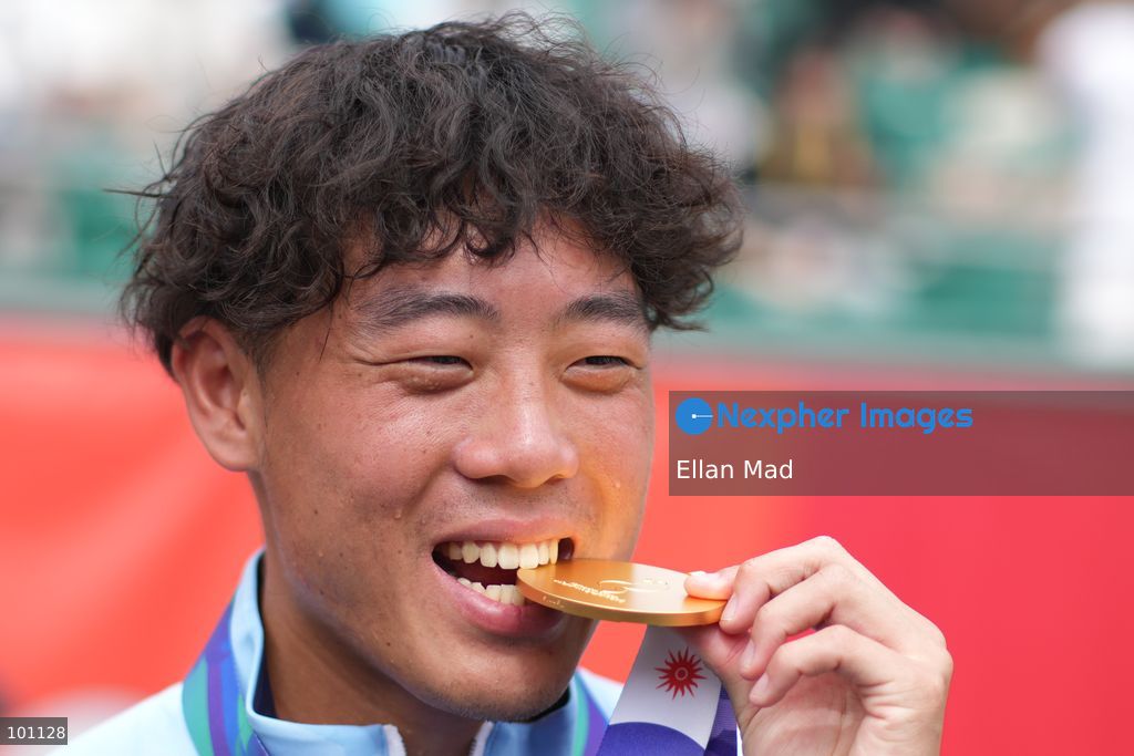 Hong Kong Tennis player, Coleman Wong Chak-lam bite the gold medal and posing photo, he wins the Men's Final at the 2026 Asian games on October 3, 2026 in Nagoya, Japan. (Photo by Ellan Mad/Nexpher Images)