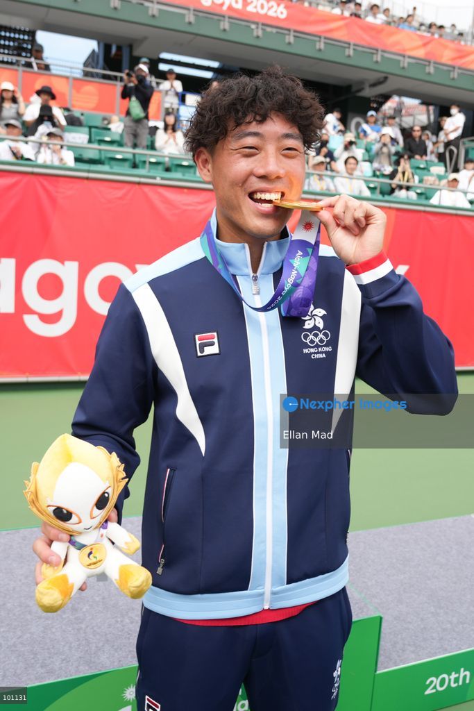 Hong Kong Tennis player, Coleman Wong Chak-lam bite the gold medal and posing photo, he wins the Men's Final at the 2026 Asian games on October 3, 2026 in Nagoya, Japan. (Photo by Ellan Mad/Nexpher Images)