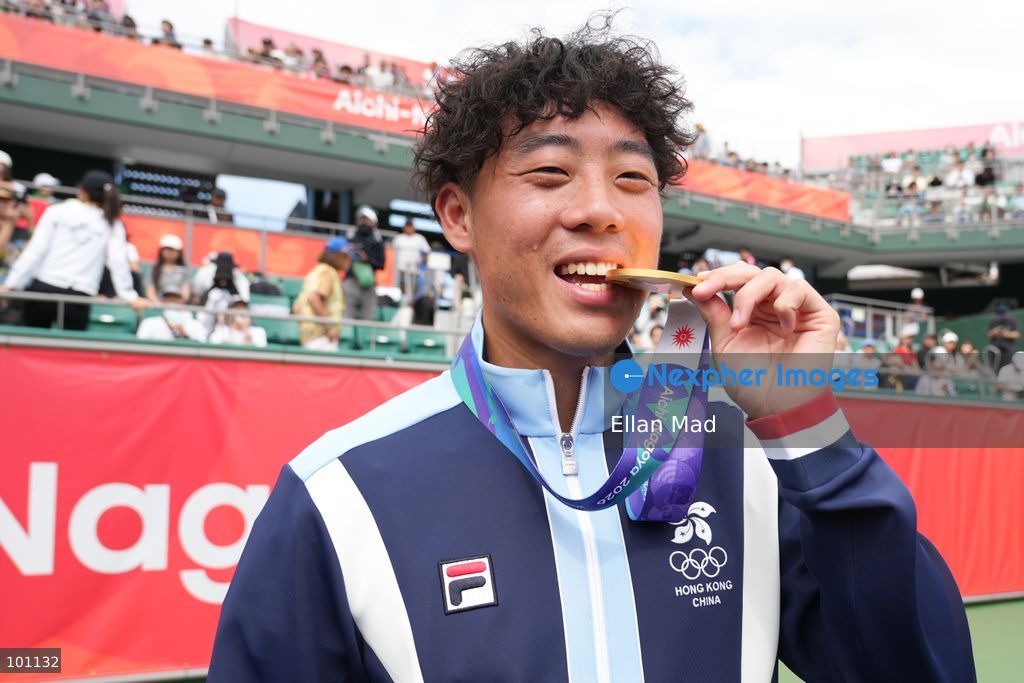 Hong Kong Tennis player, Coleman Wong Chak-lam bite the gold medal and posing photo, he wins the Men's Final at the 2026 Asian games on October 3, 2026 in Nagoya, Japan. (Photo by Ellan Mad/Nexpher Images)