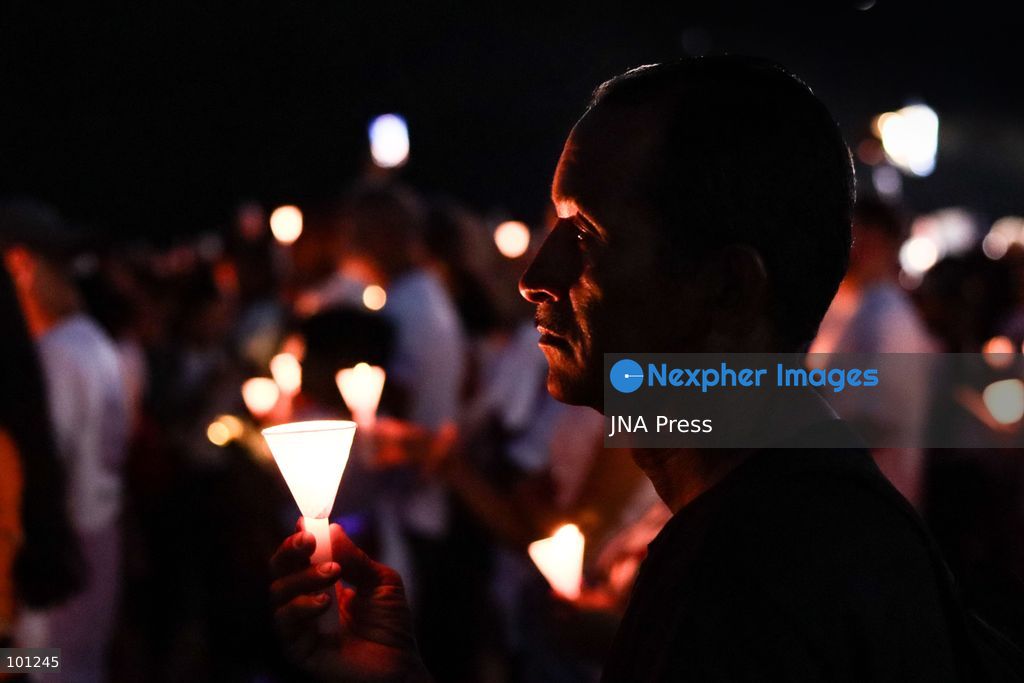 LA GUAIRA, VENEZUELA, OCTOBER 2, 2026: Families of victims, survivors and rescue workers gather during the "Haz de Luz" vigil in La Guaira to commemorate 100 days since the devastating earthquakes of June 24. Participants lit candles and joined prayers in memory of those killed and missing, while beams of light were projected into the sky near areas heavily damaged by the disaster. The commemorative event brought together residents, volunteers and emergency workers as recovery and search efforts continue in parts of La Guaira. Photo by Mario Flores/ JNA Press. (Photo by Mario Flores/JNA Press via Nexpher Images)