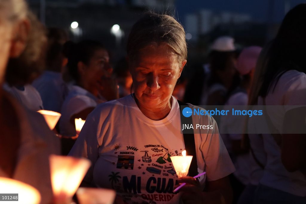 LA GUAIRA, VENEZUELA, OCTOBER 2, 2026: Families of victims, survivors and rescue workers gather during the "Haz de Luz" vigil in La Guaira to commemorate 100 days since the devastating earthquakes of June 24. Participants lit candles and joined prayers in memory of those killed and missing, while beams of light were projected into the sky near areas heavily damaged by the disaster. The commemorative event brought together residents, volunteers and emergency workers as recovery and search efforts continue in parts of La Guaira. Photo by Mario Flores/ JNA Press. (Photo by Mario Flores/JNA Press via Nexpher Images)