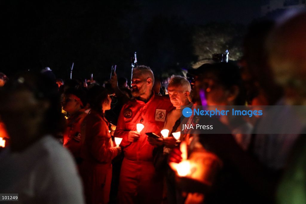 LA GUAIRA, VENEZUELA, OCTOBER 2, 2026: Families of victims, survivors and rescue workers gather during the "Haz de Luz" vigil in La Guaira to commemorate 100 days since the devastating earthquakes of June 24. Participants lit candles and joined prayers in memory of those killed and missing, while beams of light were projected into the sky near areas heavily damaged by the disaster. The commemorative event brought together residents, volunteers and emergency workers as recovery and search efforts continue in parts of La Guaira. Photo by Mario Flores/ JNA Press. (Photo by Mario Flores/JNA Press via Nexpher Images)
