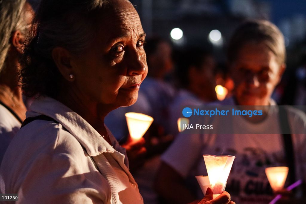 LA GUAIRA, VENEZUELA, OCTOBER 2, 2026: Families of victims, survivors and rescue workers gather during the "Haz de Luz" vigil in La Guaira to commemorate 100 days since the devastating earthquakes of June 24. Participants lit candles and joined prayers in memory of those killed and missing, while beams of light were projected into the sky near areas heavily damaged by the disaster. The commemorative event brought together residents, volunteers and emergency workers as recovery and search efforts continue in parts of La Guaira. Photo by Mario Flores/ JNA Press. (Photo by Mario Flores/JNA Press via Nexpher Images)