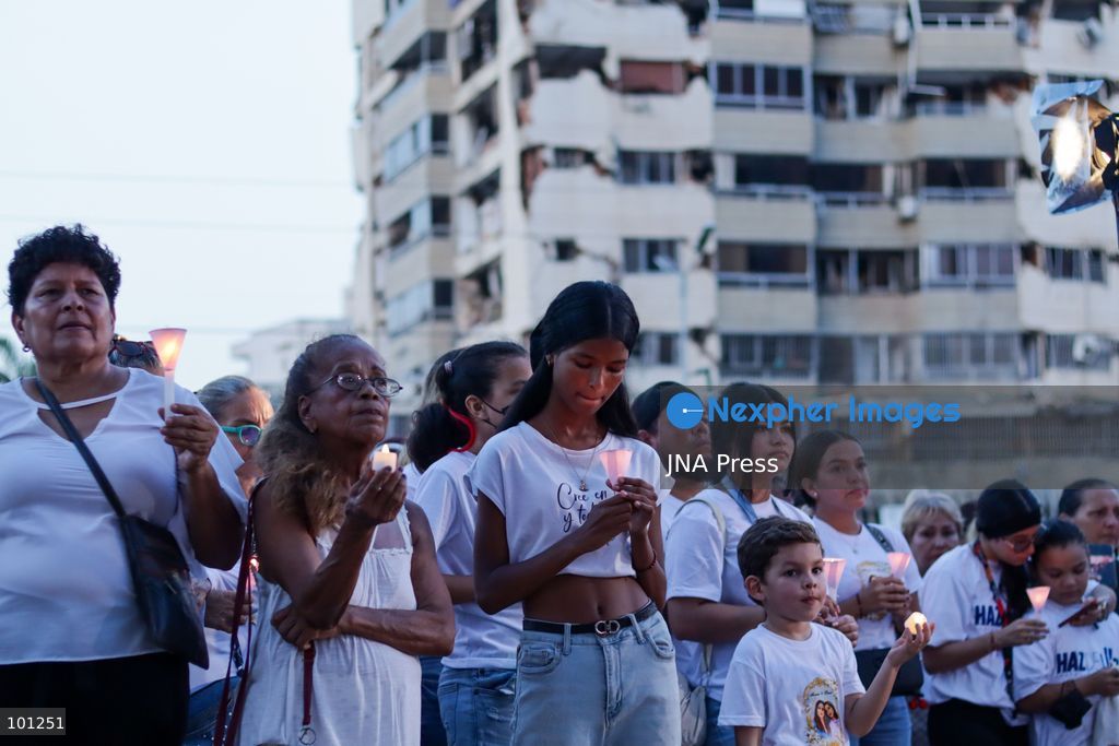 LA GUAIRA, VENEZUELA, OCTOBER 2, 2026: Families of victims, survivors and rescue workers gather during the "Haz de Luz" vigil in La Guaira to commemorate 100 days since the devastating earthquakes of June 24. Participants lit candles and joined prayers in memory of those killed and missing, while beams of light were projected into the sky near areas heavily damaged by the disaster. The commemorative event brought together residents, volunteers and emergency workers as recovery and search efforts continue in parts of La Guaira. Photo by Mario Flores/ JNA Press. (Photo by Mario Flores/JNA Press via Nexpher Images)