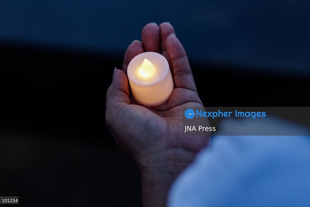 LA GUAIRA, VENEZUELA, OCTOBER 2, 2026: Families of victims, survivors and rescue workers gather during the "Haz de Luz" vigil in La Guaira to commemorate 100 days since the devastating earthquakes of June 24. Participants lit candles and joined prayers in memory of those killed and missing, while beams of light were projected into the sky near areas heavily damaged by the disaster. The commemorative event brought together residents, volunteers and emergency workers as recovery and search efforts continue in parts of La Guaira. Photo by Mario Flores/ JNA Press. (Photo by Mario Flores/JNA Press via Nexpher Images)