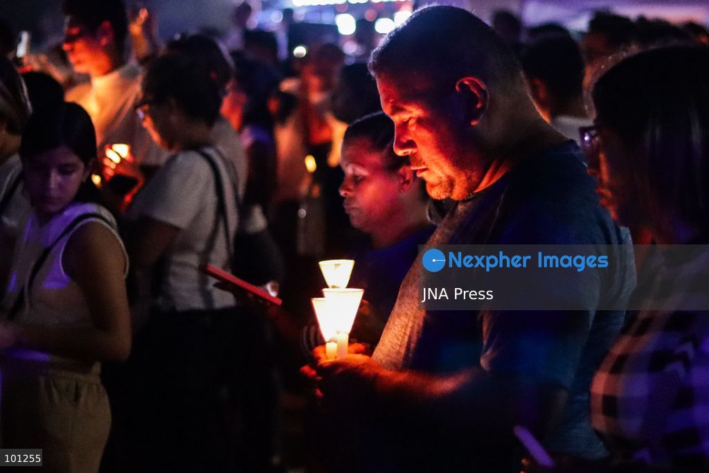 LA GUAIRA, VENEZUELA, OCTOBER 2, 2026: Families of victims, survivors and rescue workers gather during the "Haz de Luz" vigil in La Guaira to commemorate 100 days since the devastating earthquakes of June 24. Participants lit candles and joined prayers in memory of those killed and missing, while beams of light were projected into the sky near areas heavily damaged by the disaster. The commemorative event brought together residents, volunteers and emergency workers as recovery and search efforts continue in parts of La Guaira. Photo by Mario Flores/ JNA Press. (Photo by Mario Flores/JNA Press via Nexpher Images)