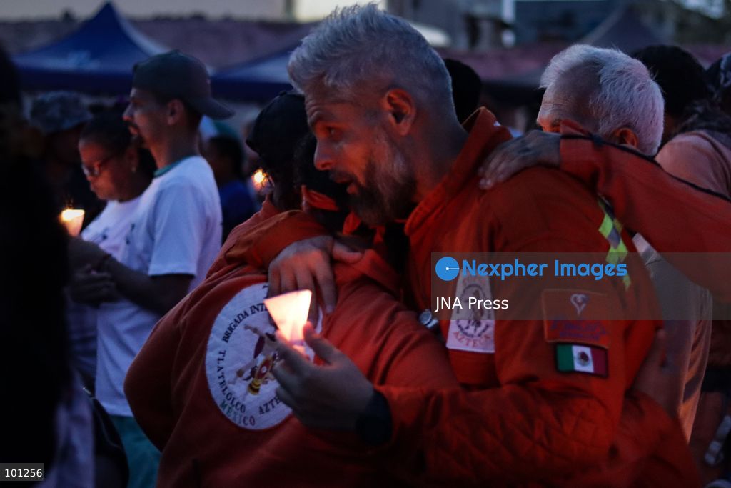 LA GUAIRA, VENEZUELA, OCTOBER 2, 2026: Families of victims, survivors and rescue workers gather during the "Haz de Luz" vigil in La Guaira to commemorate 100 days since the devastating earthquakes of June 24. Participants lit candles and joined prayers in memory of those killed and missing, while beams of light were projected into the sky near areas heavily damaged by the disaster. The commemorative event brought together residents, volunteers and emergency workers as recovery and search efforts continue in parts of La Guaira. Photo by Mario Flores/ JNA Press. (Photo by Mario Flores/JNA Press via Nexpher Images)