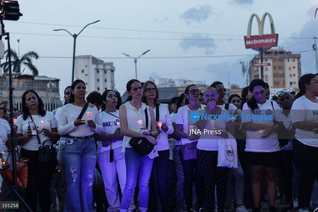 LA GUAIRA, VENEZUELA, OCTOBER 2, 2026: Families of victims, survivors and rescue workers gather during the "Haz de Luz" vigil in La Guaira to commemorate 100 days since the devastating earthquakes of June 24. Participants lit candles and joined prayers in memory of those killed and missing, while beams of light were projected into the sky near areas heavily damaged by the disaster. The commemorative event brought together residents, volunteers and emergency workers as recovery and search efforts continue in parts of La Guaira. Photo by Mario Flores/ JNA Press. (Photo by Mario Flores/JNA Press via Nexpher Images)