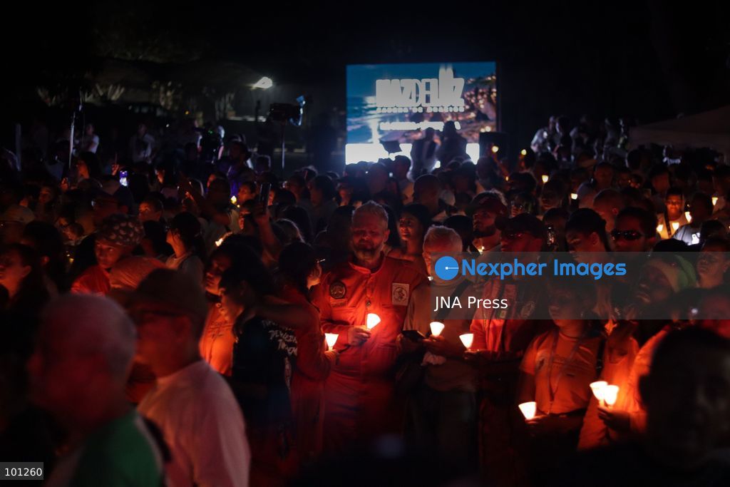 LA GUAIRA, VENEZUELA, OCTOBER 2, 2026: Families of victims, survivors and rescue workers gather during the "Haz de Luz" vigil in La Guaira to commemorate 100 days since the devastating earthquakes of June 24. Participants lit candles and joined prayers in memory of those killed and missing, while beams of light were projected into the sky near areas heavily damaged by the disaster. The commemorative event brought together residents, volunteers and emergency workers as recovery and search efforts continue in parts of La Guaira. Photo by Mario Flores/ JNA Press. (Photo by Mario Flores/JNA Press via Nexpher Images)