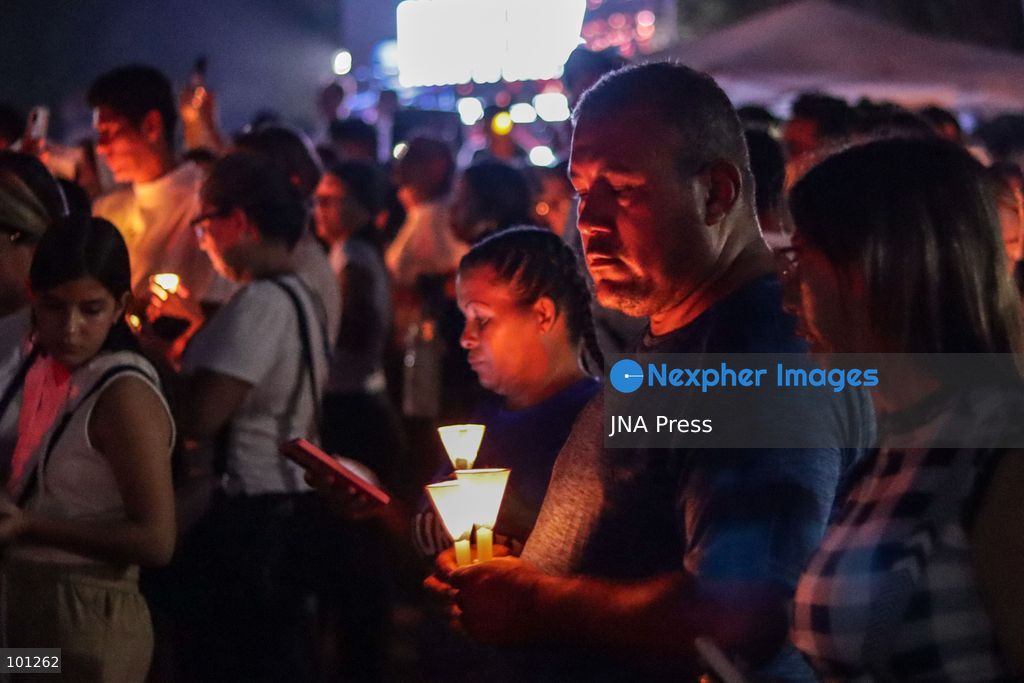 LA GUAIRA, VENEZUELA, OCTOBER 2, 2026: Families of victims, survivors and rescue workers gather during the "Haz de Luz" vigil in La Guaira to commemorate 100 days since the devastating earthquakes of June 24. Participants lit candles and joined prayers in memory of those killed and missing, while beams of light were projected into the sky near areas heavily damaged by the disaster. The commemorative event brought together residents, volunteers and emergency workers as recovery and search efforts continue in parts of La Guaira. Photo by Mario Flores/ JNA Press. (Photo by Mario Flores/JNA Press via Nexpher Images)