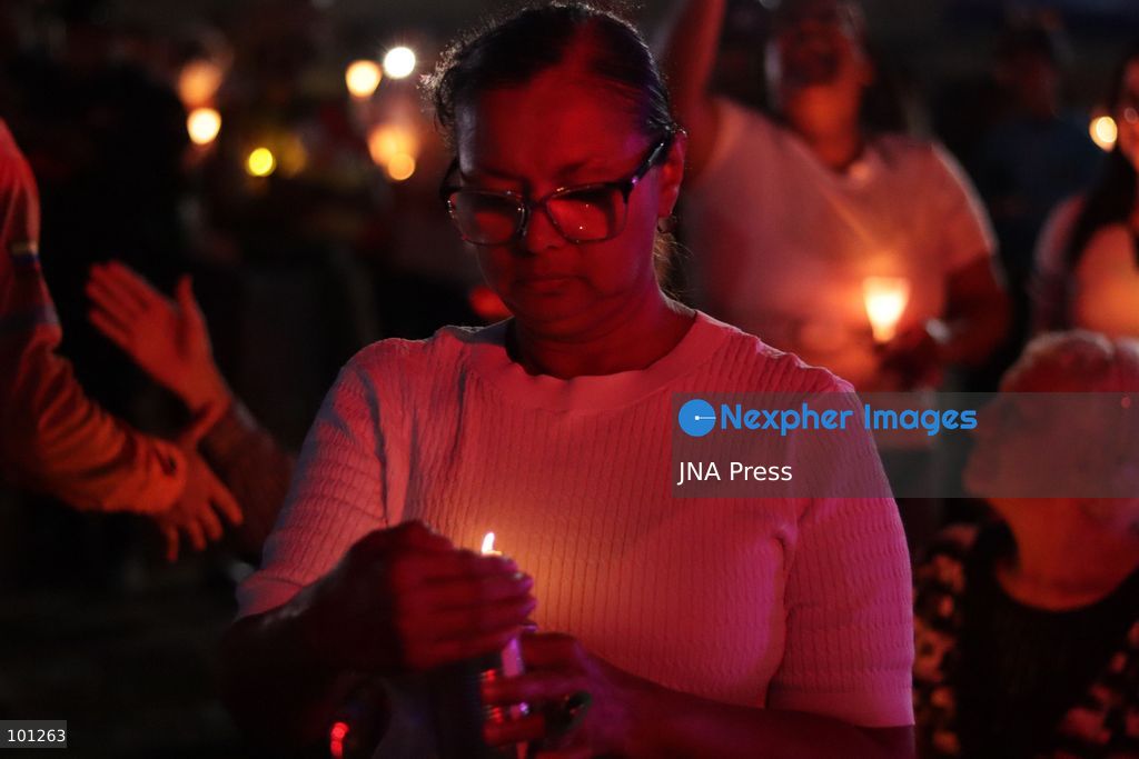 LA GUAIRA, VENEZUELA, OCTOBER 2, 2026: Families of victims, survivors and rescue workers gather during the "Haz de Luz" vigil in La Guaira to commemorate 100 days since the devastating earthquakes of June 24. Participants lit candles and joined prayers in memory of those killed and missing, while beams of light were projected into the sky near areas heavily damaged by the disaster. The commemorative event brought together residents, volunteers and emergency workers as recovery and search efforts continue in parts of La Guaira. Photo by Mario Flores/ JNA Press. (Photo by Mario Flores/JNA Press via Nexpher Images)