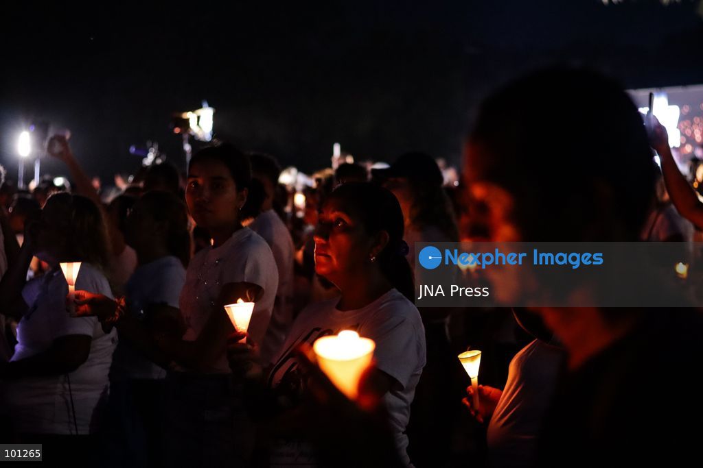 LA GUAIRA, VENEZUELA, OCTOBER 2, 2026: Families of victims, survivors and rescue workers gather during the "Haz de Luz" vigil in La Guaira to commemorate 100 days since the devastating earthquakes of June 24. Participants lit candles and joined prayers in memory of those killed and missing, while beams of light were projected into the sky near areas heavily damaged by the disaster. The commemorative event brought together residents, volunteers and emergency workers as recovery and search efforts continue in parts of La Guaira. Photo by Mario Flores/ JNA Press. (Photo by Mario Flores/JNA Press via Nexpher Images)