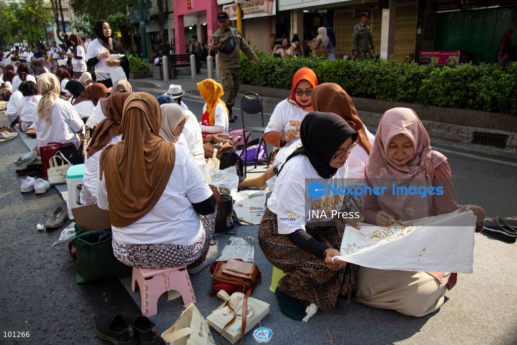 YOGYAKARTA, INDONESIA, OCTOBER 3, 2026: A total of 1,001 batik artists create traditional designs on fabric using canting tools along Malioboro Street in Yogyakarta during the "Symphony of 1001 Batik Artists" event. The mass batik-making activity was held as part of celebrations marking the 270th anniversary of Yogyakarta City and Indonesia's National Batik Day 2026. Photo by Topen Sapurta / JNA Press. (Photo by Topen Anggara Saputra/JNA Press via Nexpher Images)