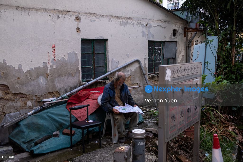 A man sitting on a chair reading a newspaper on October 3, 2026 in Hong Kong (Photo by Vernon Yuen/Nexpher Images)