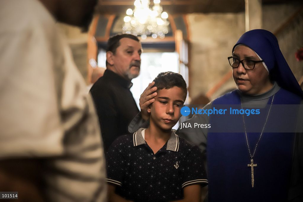 GAZA, PALESTINE – OCTOBER 3, 2026: Mourners attended the funeral of Christian mother Maysa Abu Dawood and her daughter Mary at Saint Porphyrius Church in Gaza City on Saturday, after they were killed early in the morning when an Israeli airstrike hit their residential apartment in the city. Mukhtars, community reconciliation figures and members of the Palestinian Civil Defense attended the funeral. The funeral was held at Saint Porphyrius Church, where mourners gathered to pay their respects to the mother and daughter. Photo by Mohammed M. Skaik / JNA Press. (Photo by Mohammed M Skaik/JNA Press via Nexpher Images)
