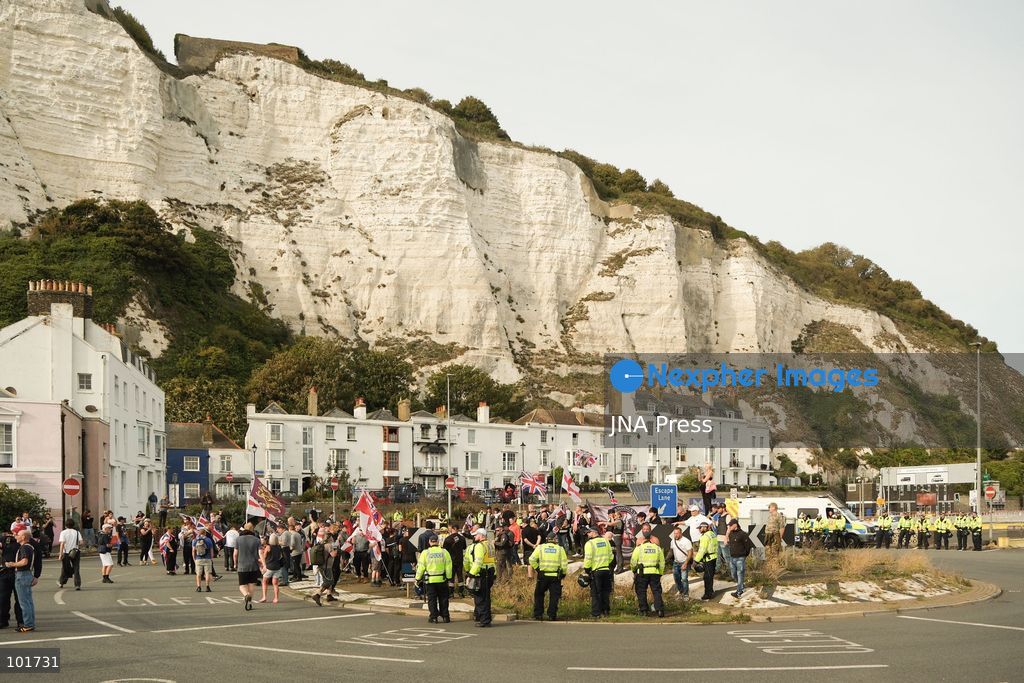 DOVER, UNITED KINGDOM, OCTOBER 3, 2026: Anti-immigration protesters and anti-racism counter-protesters gather during rival demonstrations in Dover, Kent. Anti-immigration demonstrators carrying Union flags and St George's flags displayed banners calling for deportations and an end to small-boat crossings, while counter-protesters gathered nearby. Police maintained a significant presence between the groups and monitored the demonstrations. Photo by Marc Lewis / JNA Press. (Photo by Marc Lewis/JNA Press via Nexpher Images)