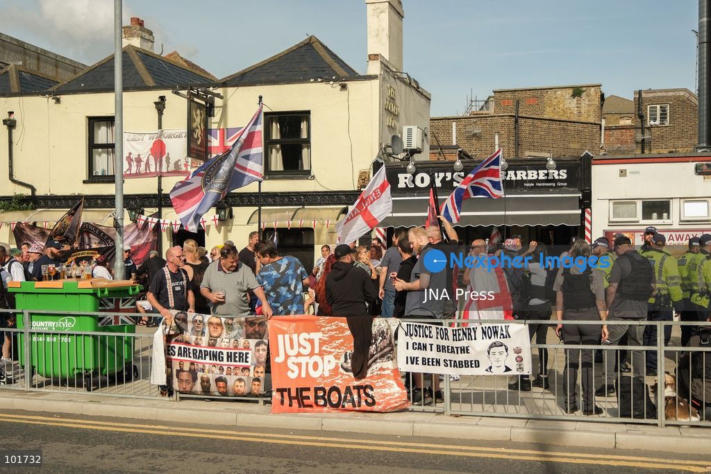 DOVER, UNITED KINGDOM, OCTOBER 3, 2026: Anti-immigration protesters and anti-racism counter-protesters gather during rival demonstrations in Dover, Kent. Anti-immigration demonstrators carrying Union flags and St George's flags displayed banners calling for deportations and an end to small-boat crossings, while counter-protesters gathered nearby. Police maintained a significant presence between the groups and monitored the demonstrations. Photo by Marc Lewis / JNA Press. (Photo by Marc Lewis/JNA Press via Nexpher Images)