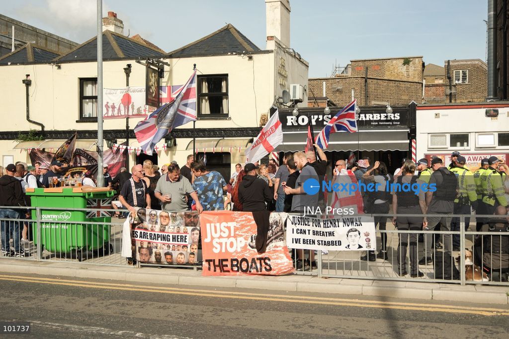 DOVER, UNITED KINGDOM, OCTOBER 3, 2026: Anti-immigration protesters and anti-racism counter-protesters gather during rival demonstrations in Dover, Kent. Anti-immigration demonstrators carrying Union flags and St George's flags displayed banners calling for deportations and an end to small-boat crossings, while counter-protesters gathered nearby. Police maintained a significant presence between the groups and monitored the demonstrations. Photo by Marc Lewis / JNA Press. (Photo by Marc Lewis/JNA Press via Nexpher Images)