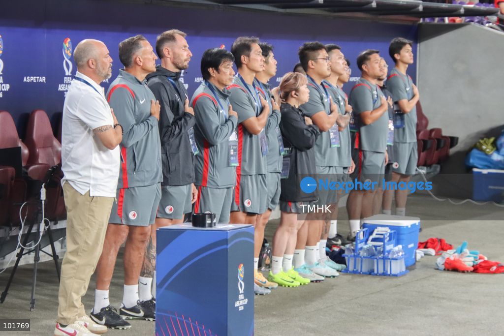 Members of the Hong Kong, China coaching staff sing the national anthem ahead of the FIFA ASEAN Challenge Cup final against Cambodia at Kai Tak Stadium in Hong Kong on October 3, 2026. (Photo by Gordon Choi/TMHK via Nexpher Images)