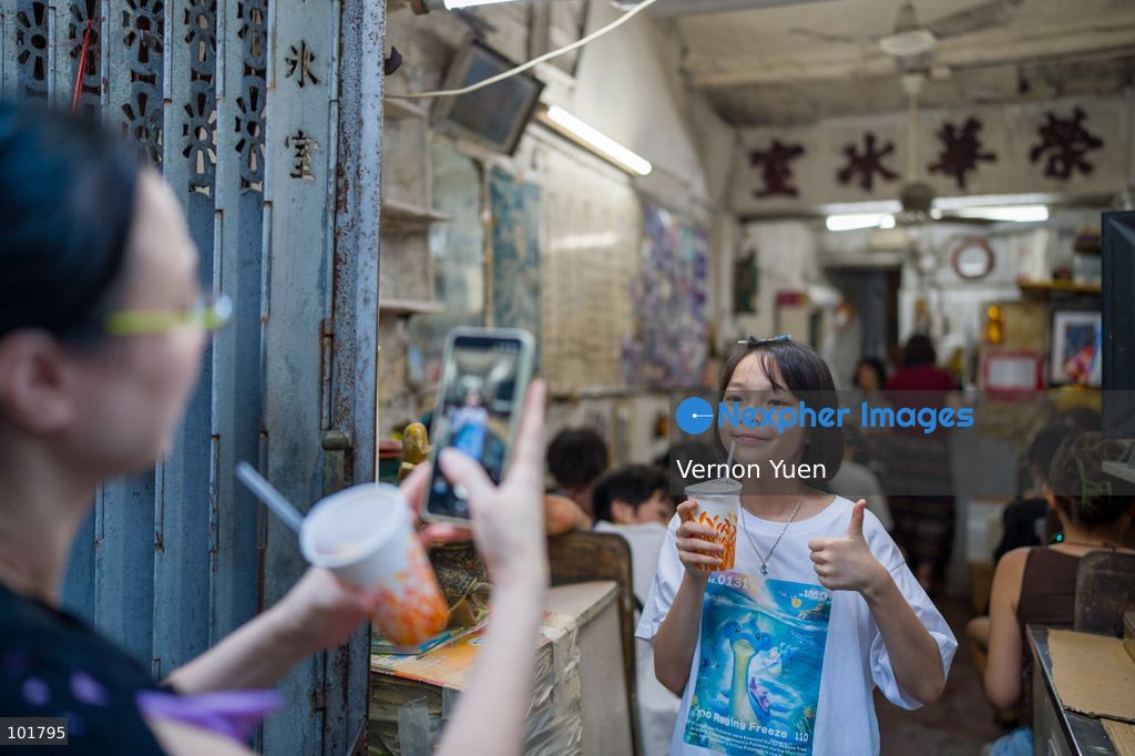 A girl holding posing for a photo at Wing Wah Cafe at Cha Kwo Ling Village on October 4, 2026 in Hong Kong. Two traditional “Bing Sutt” style restaurants at Cha Kwo Ling Village will shut down after today. (Photo by Vernon Yuen/Nexpher Images)