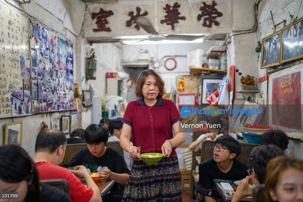 A worker holding a bowl of noodles inside Wing Wah Cafe at Cha Kwo Ling Village on October 4, 2026 in Hong Kong. Two traditional “Bing Sutt” style restaurants at Cha Kwo Ling Village will shut down after today. (Photo by Vernon Yuen/Nexpher Images)