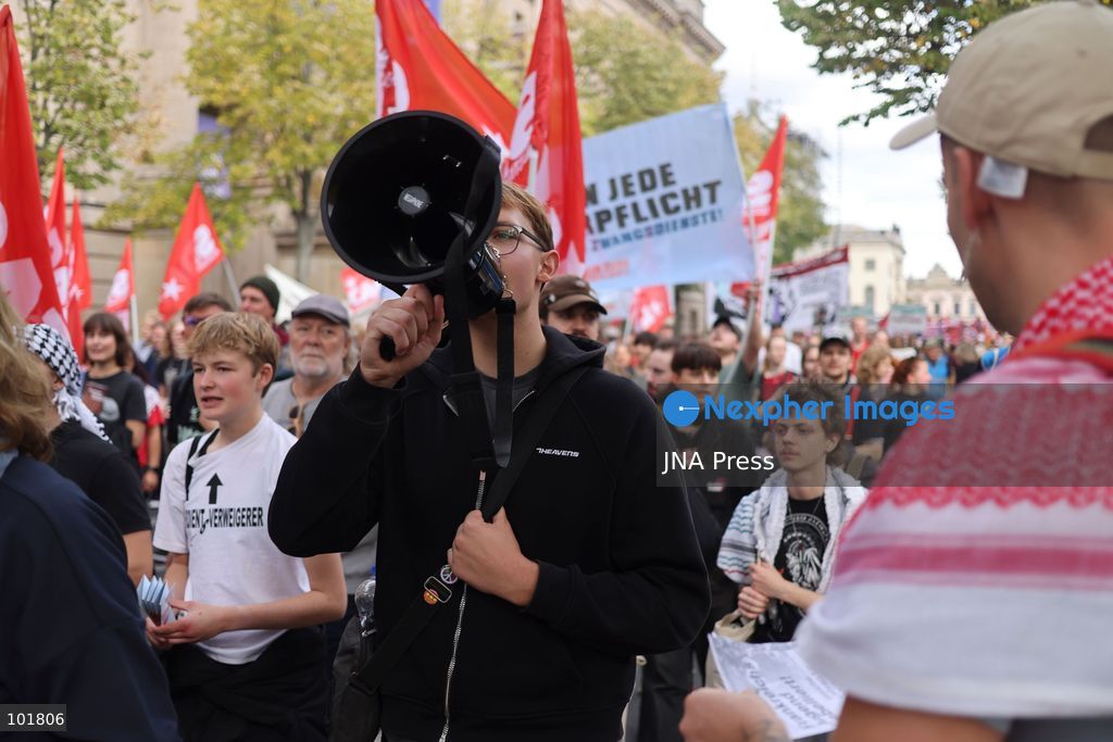 BERLIN, GERMANY, OCTOBER 3, 2026: Thousands of demonstrators march through central Berlin during a protest against Germany's military buildup, increased defense spending and the possible reintroduction of compulsory military service. Protesters called for greater investment in healthcare, housing, education and other social services instead of military spending, while participants also demonstrated against German arms deliveries and support for Israel amid the war in Gaza. The march began at the Brandenburg Gate and continued through central Berlin before returning to the area. Photo by Zaira Bilagini / JNA Press. (Photo by Zaira Biagini/JNA Press via Nexpher Images)