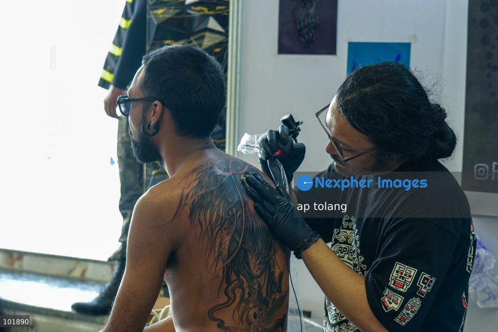 LALITPUR, NEPAL, October 4, 2026: A tattoo artist tattoos a customer during the Himalayan Tattoo Summit 0.3 at Majestic Grand in Lalitpur, Nepal. The summit brings together more than 200 tattoo artists, over 100 studios, and industry professionals from around the world to celebrate tattoo culture, heritage, creativity, and lifestyle. (Photo by ap tolang/Nexpher Images)