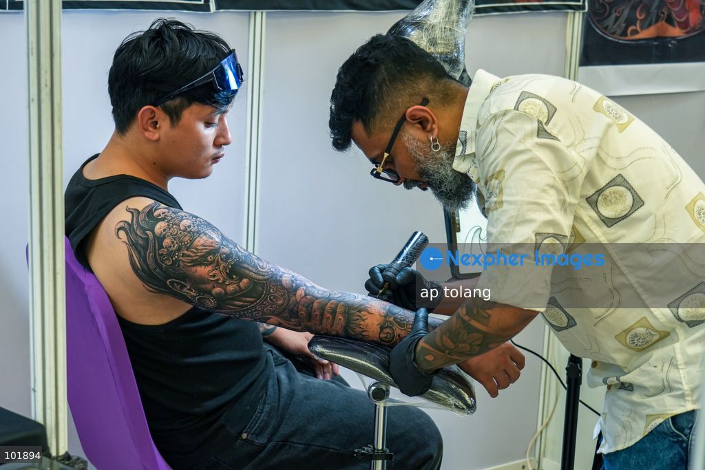 LALITPUR, NEPAL, October 4, 2026: A tattoo artist tattoos a customer during the Himalayan Tattoo Summit 0.3 at Majestic Grand in Lalitpur, Nepal. The summit brings together more than 200 tattoo artists, over 100 studios, and industry professionals from around the world to celebrate tattoo culture, heritage, creativity, and lifestyle. (Photo by ap tolang/Nexpher Images)
