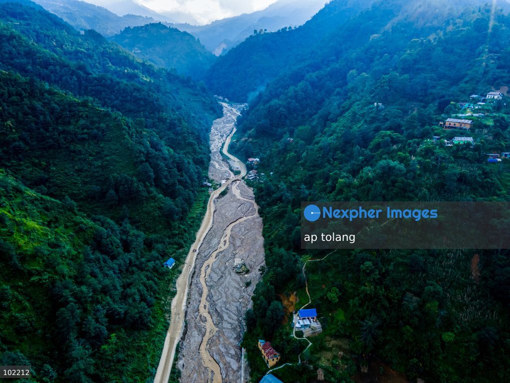 Kavrepalanchok, NEPAL, October 3, 2026: AAn aerial view shows changes along the banks of the Salamdo River two years after flooding in Patikharka, Kavrepalanchok, Nepal. While the landscape shows signs of recovery, the river has expanded into some areas, with flood-damaged sections of the riverbank still visible. Some areas continue to bear scars from the disaster, highlighting its lasting impact. (Photo by ap tolang/Nexpher Images)