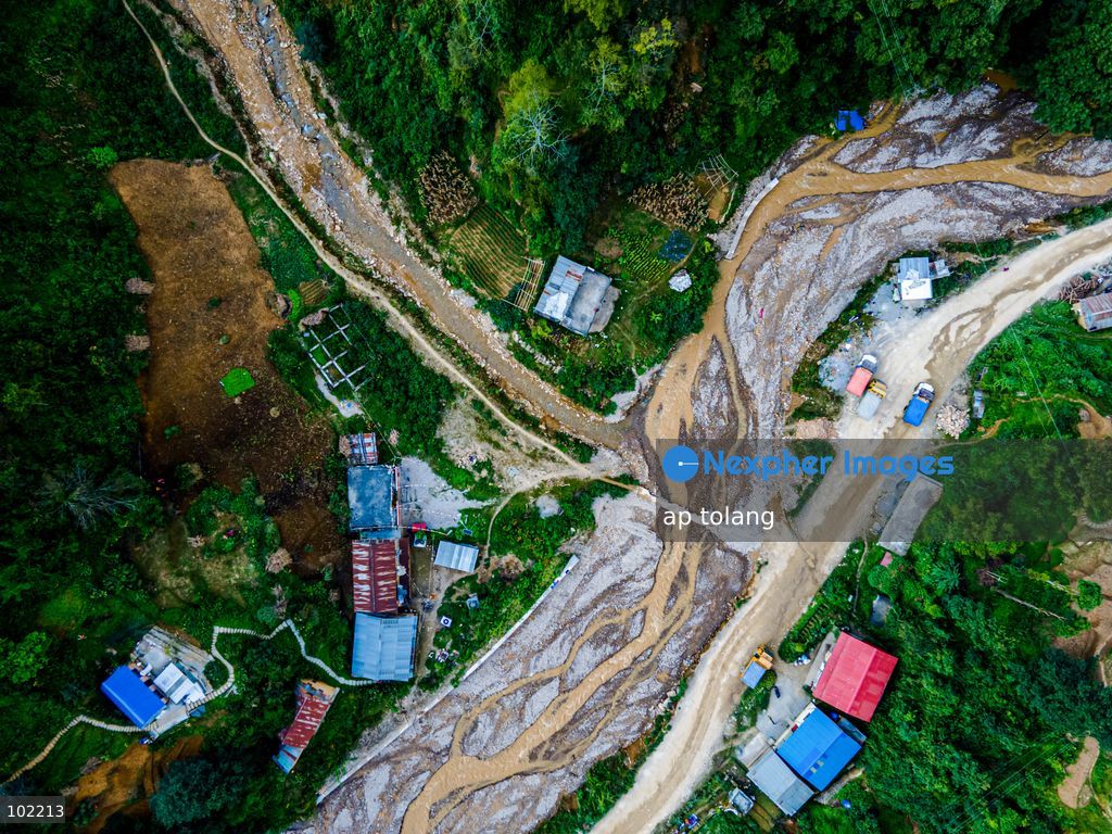 Kavrepalanchok, NEPAL, October 3, 2026: An aerial view shows changes along the banks of the Salamdo River two years after flooding in Patikharka, Kavrepalanchok, Nepal. While the landscape shows signs of recovery, the river has expanded into some areas, with flood-damaged sections of the riverbank still visible. Some areas continue to bear scars from the disaster, highlighting its lasting impact. (Photo by ap tolang/Nexpher Images)