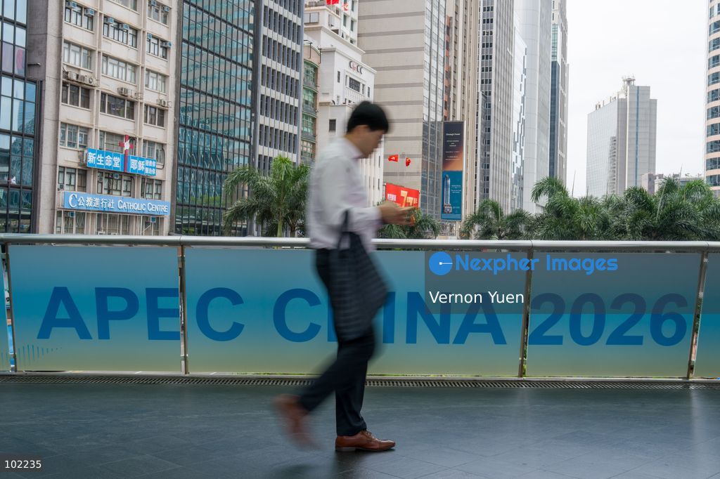 TOP PICS - A man walks pass an APEC 2026 banner on a footbridge on October 6, 2026 in Hong Kong. (Photo by Vernon Yuen/Nexpher Images)
