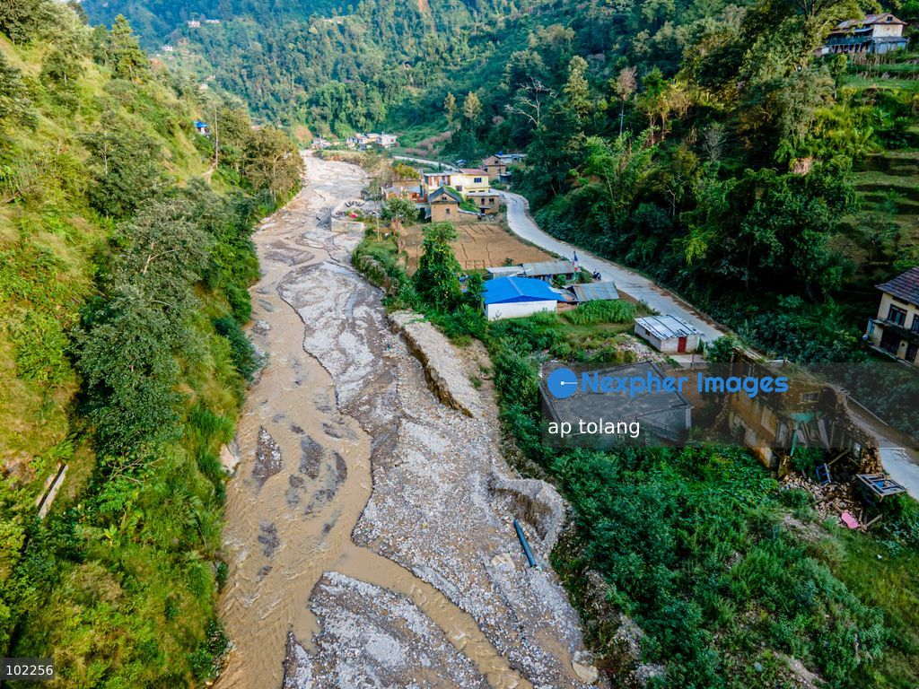 TOP PICS - Kavrepalanchok, NEPAL, October 3, 2026: An aerial view shows changes along the banks of the Salamdo River two years after flooding in Patikharka, Kavrepalanchok, Nepal. While the landscape shows signs of recovery, the river has expanded into some areas, with flood-damaged sections of the riverbank still visible. Some areas continue to bear scars from the disaster, highlighting its lasting impact. (Photo by ap tolang/Nexpher Images)